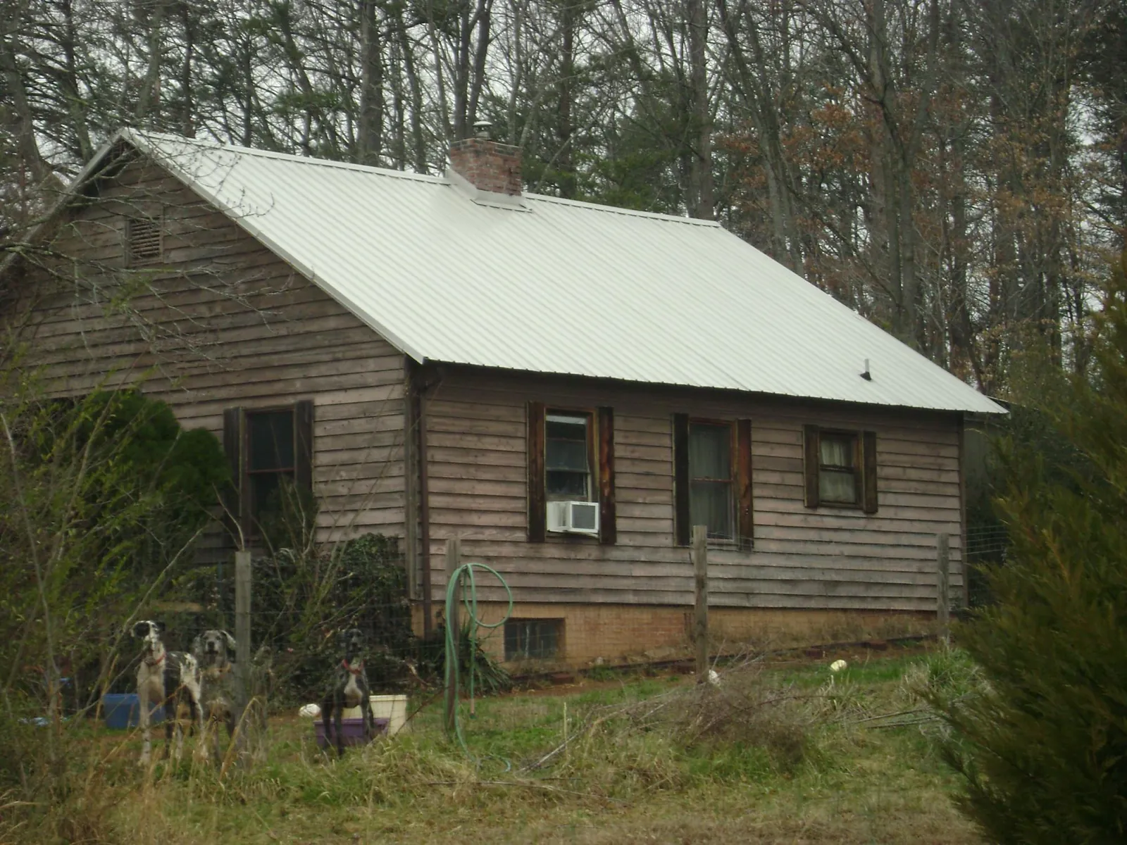 White metal roof on an old wood sided farmhouse, from a Metal Roof Installation job in Ankeny